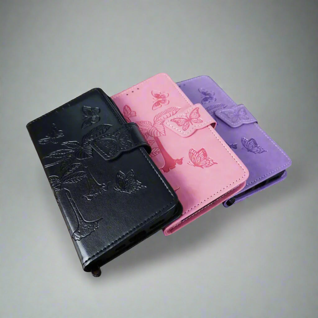 Three phone cases in black, pink, and purple with butterfly designs on a light gray background.